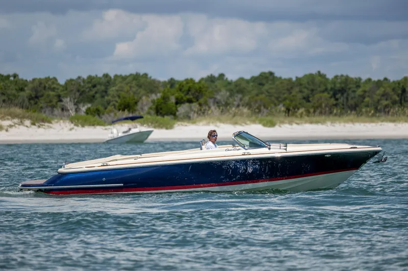  Yacht Photos Pics 2022 Chris-Craft Launch 27 boat cruising on a scenic waterway.