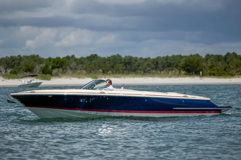  Yacht Photos Pics 2022 Chris-Craft Launch 27 boat cruising on a scenic waterway.