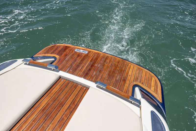  Yacht Photos Pics 2022 Chris-Craft Launch 27 boat with elegant wooden deck on water.