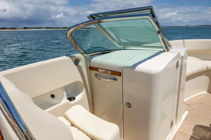  Yacht Photos Pics 2022 Chris-Craft Launch 27 boat interior with open windshield, on a sunny day at sea.