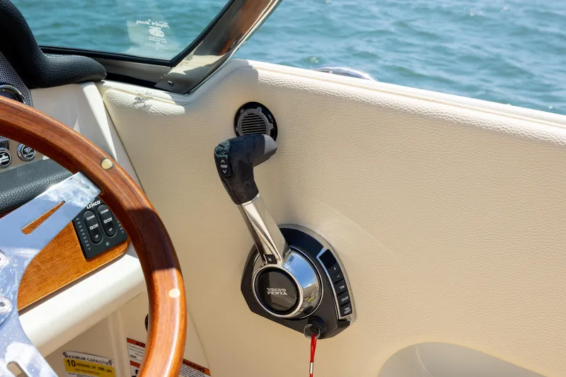  Yacht Photos Pics 2022 Chris-Craft Launch 27 boat interior with steering wheel and throttle control.