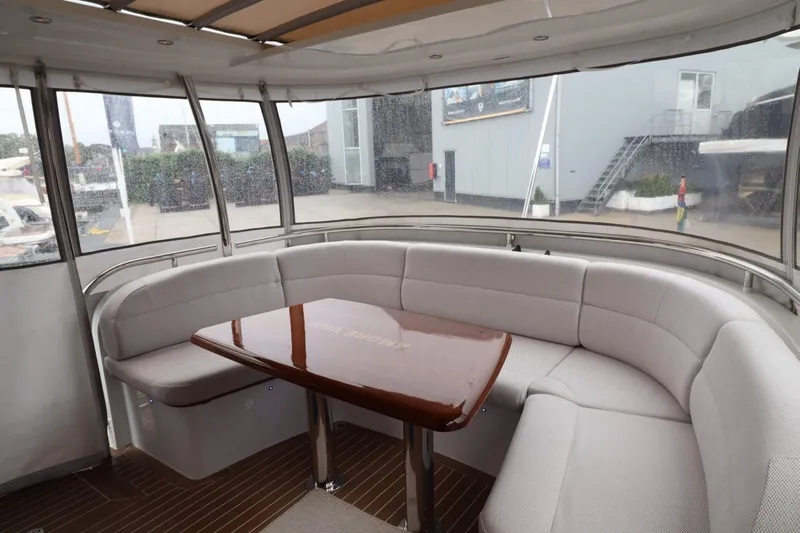  Yacht Photos Pics Luxurious interior of 2012 Vivante 55 HT yacht with elegant seating and wooden table.