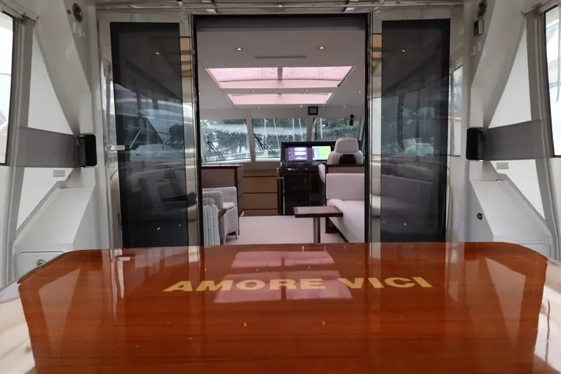  Yacht Photos Pics Luxurious interior of 2012 Vivante 55 HT yacht with "AMORE VICI" on table.