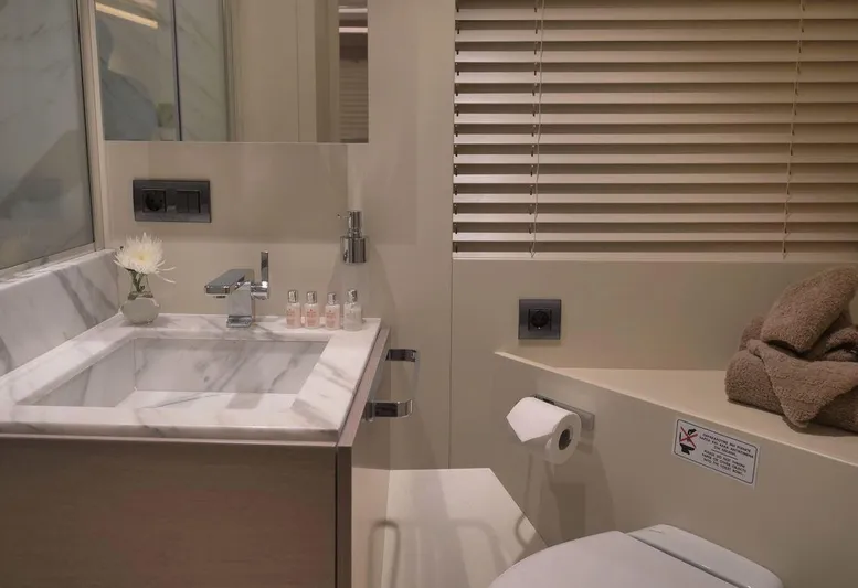  Yacht Photos Pics Luxurious yacht bathroom with marble sink, modern fixtures, and neatly arranged towels. Admiral 85, 2008.