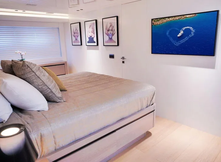  Yacht Photos Pics Luxurious yacht bedroom with modern decor, framed art, and ocean view on TV. Admiral 85, 2008.