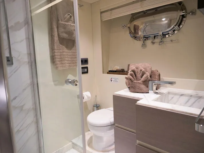  Yacht Photos Pics Luxurious yacht bathroom with modern fixtures, marble sink, and porthole window, Admiral 85, 2008.