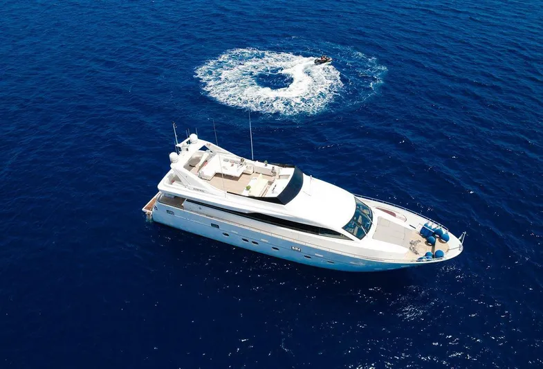  Yacht Photos Pics Luxury Admiral 85 yacht cruising in open sea, 2008 model, with jet ski nearby.