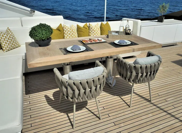  Yacht Photos Pics Luxurious yacht deck dining area with elegant table, chairs, and ocean view. Admiral 85, 2008.