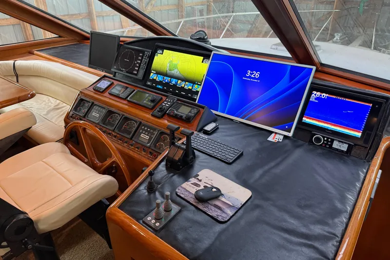 Bonnie Jean Yacht Photos Pics 1998 Ocean Alexander Pilothouse Model 584 helm with modern navigation equipment and leather seating.