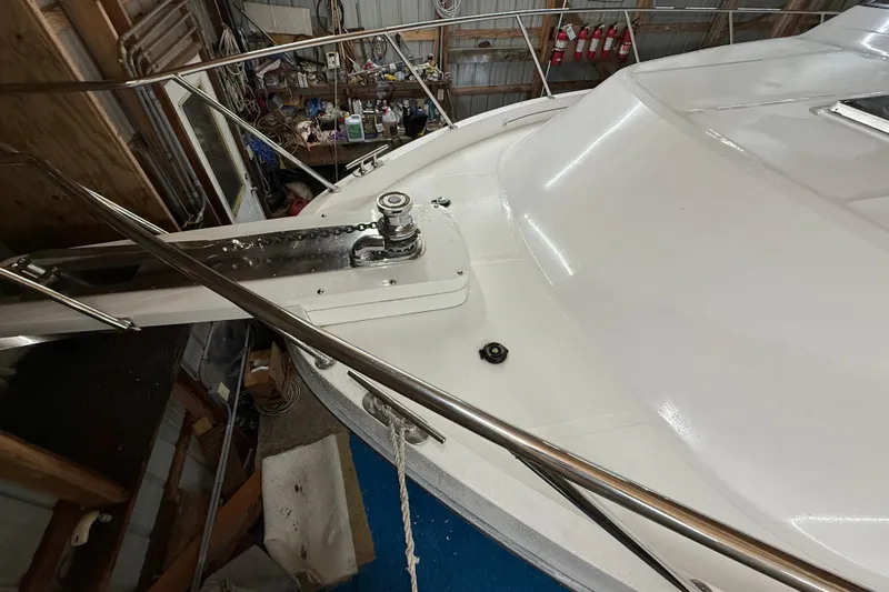 Bonnie Jean Yacht Photos Pics 1998 Ocean Alexander Pilothouse Model 584 yacht deck with winch and railing in a workshop.