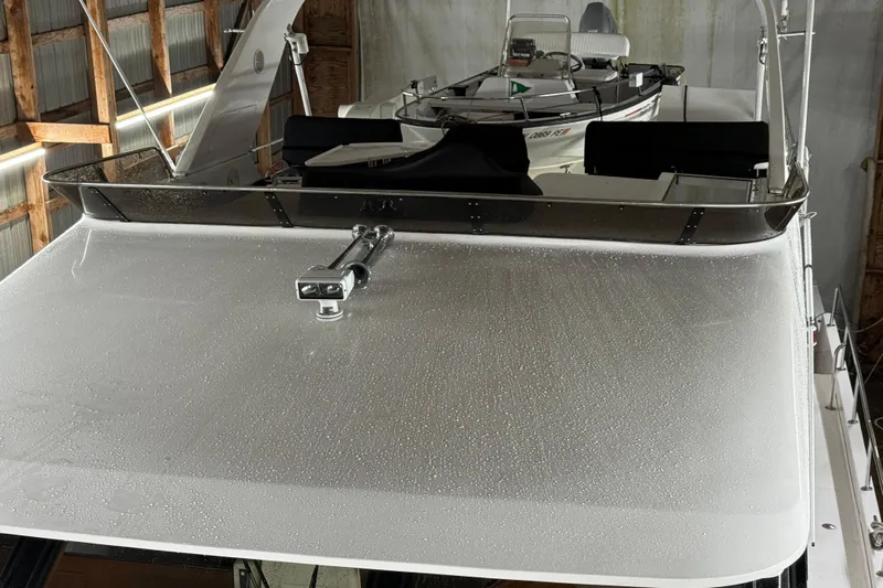 Bonnie Jean Yacht Photos Pics 1998 Ocean Alexander Pilothouse Model 584 with water droplets on deck, stored indoors.