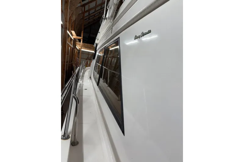 Bonnie Jean Yacht Photos Pics 1998 Ocean Alexander Pilothouse Model 584, side view in a wooden boathouse.