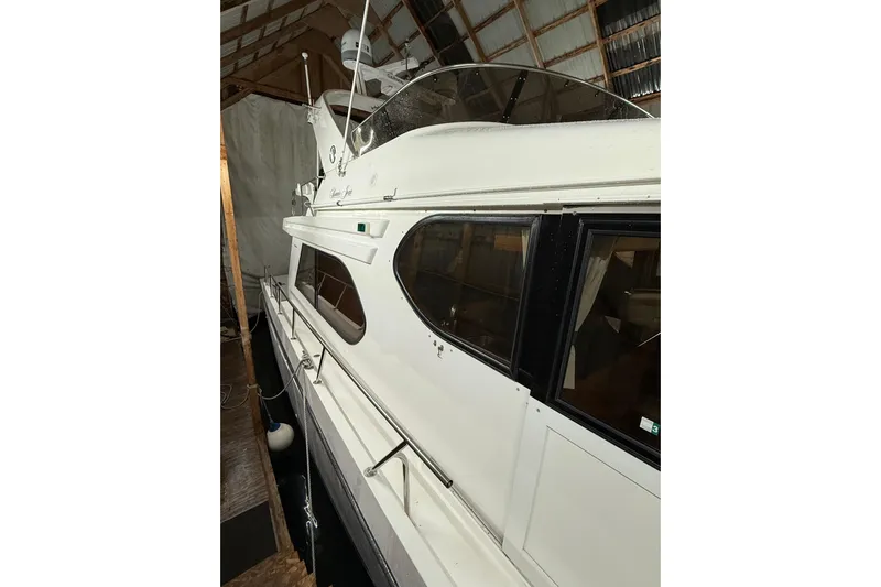 Bonnie Jean Yacht Photos Pics 1998 Ocean Alexander Pilothouse Model 584 docked in a covered marina.