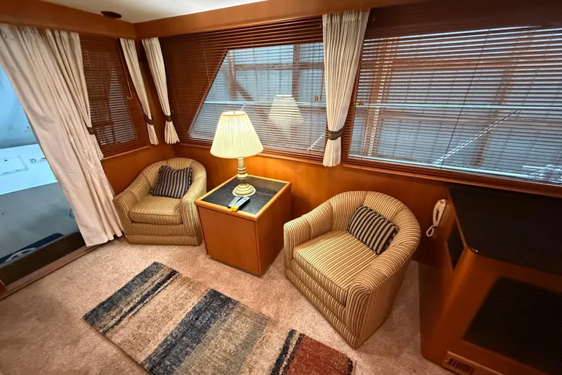 Bonnie Jean Yacht Photos Pics Cozy interior of 1998 Ocean Alexander Pilothouse Model 584 with armchairs and lamp.
