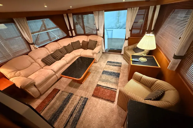 Bonnie Jean Yacht Photos Pics Luxurious interior of 1998 Ocean Alexander Pilothouse Model 584 with cozy seating and elegant decor.