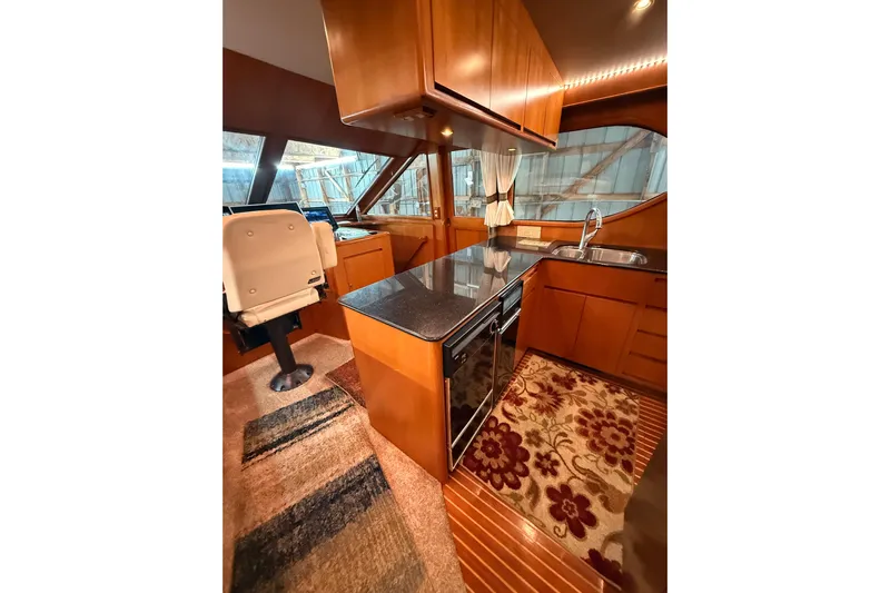 Bonnie Jean Yacht Photos Pics Luxurious 1998 Ocean Alexander Pilothouse Model 584 interior with modern kitchen and seating.