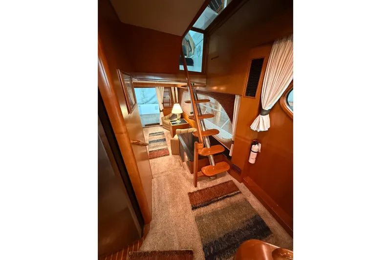 Bonnie Jean Yacht Photos Pics 1998 Ocean Alexander Pilothouse Model 584 interior with wooden stairs and cozy seating area.