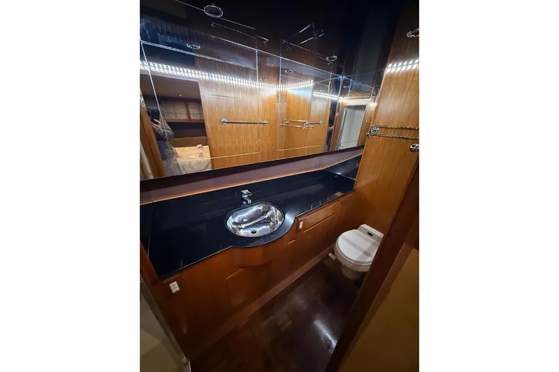 Bonnie Jean Yacht Photos Pics Luxurious bathroom in 1998 Ocean Alexander Pilothouse Model 584 yacht, featuring wood accents and modern fixtures.