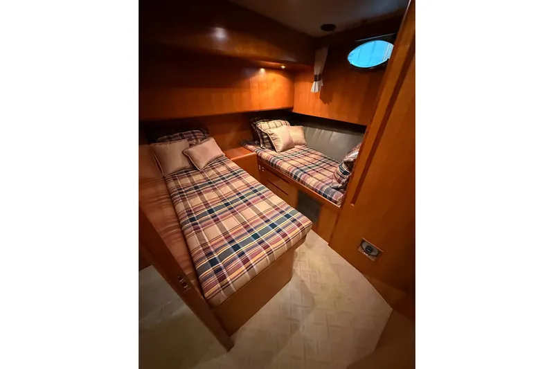 Bonnie Jean Yacht Photos Pics Cozy twin cabin in 1998 Ocean Alexander Pilothouse Model 584 yacht, featuring plaid bedding.