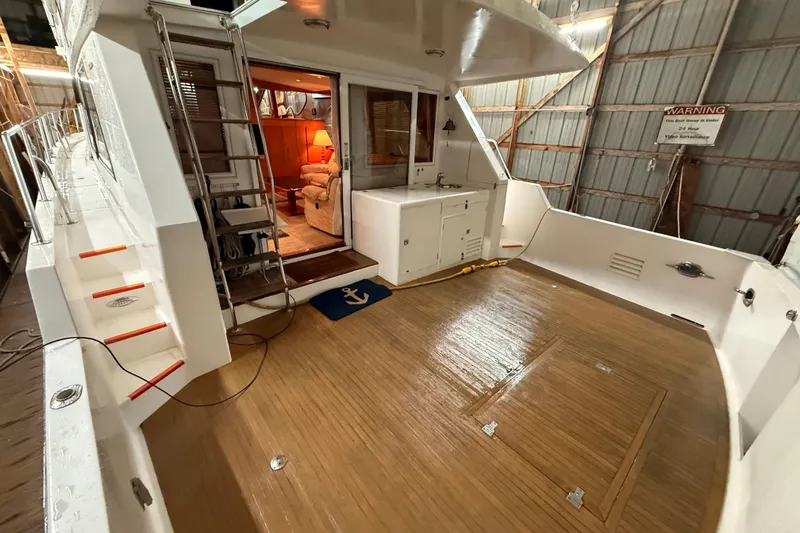 Bonnie Jean Yacht Photos Pics 1998 Ocean Alexander Pilothouse Model 584 yacht interior with wooden deck and cozy seating area.