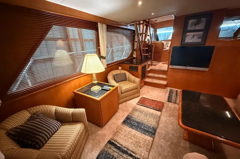 Bonnie Jean Yacht Photos Pics Luxurious interior of 1998 Ocean Alexander Pilothouse Model 584 yacht, featuring cozy seating and elegant decor.