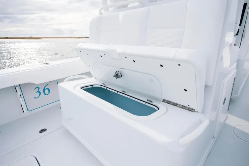  Yacht Photos Pics 2026 Yellowfin 36 Offshore boat with open storage compartment, white seating, and ocean backdrop.
