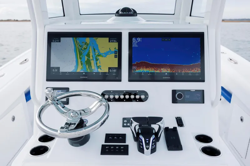  Yacht Photos Pics 2026 Yellowfin 36 Offshore boat dashboard with dual Garmin displays and steering wheel.