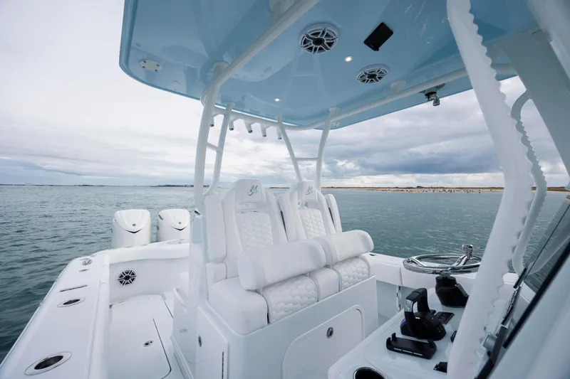  Yacht Photos Pics 2026 Yellowfin 36 Offshore boat interior with white seating and ocean backdrop.