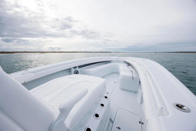  Yacht Photos Pics 2026 Yellowfin 36 Offshore boat on calm waters under cloudy sky.