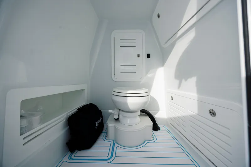  Yacht Photos Pics 2026 Yellowfin 36 Offshore boat interior with modern marine toilet and storage compartments.