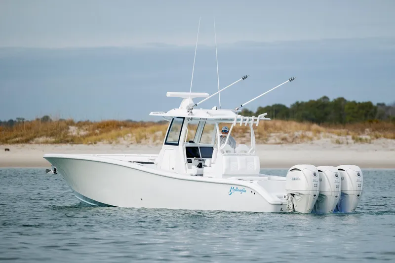  Yacht Photos Pics 2026 Yellowfin 36 Offshore boat with triple engines on calm water.
