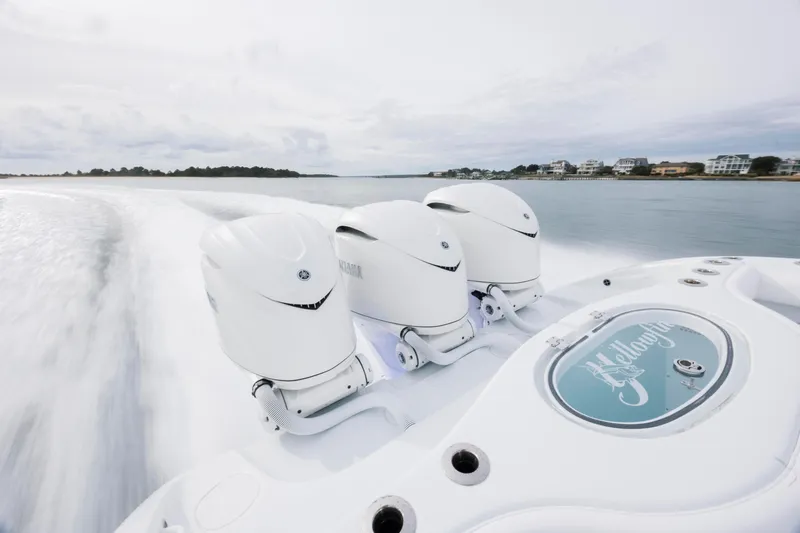  Yacht Photos Pics 2026 Yellowfin 36 Offshore boat with triple outboard engines cruising on water.