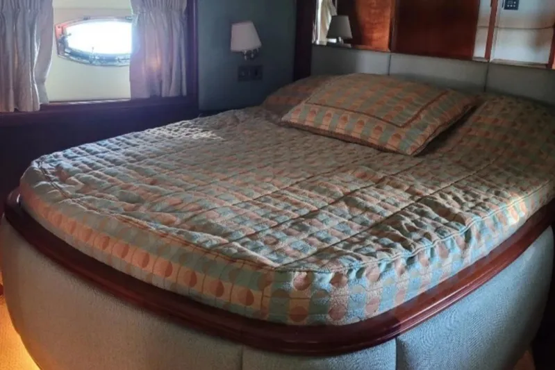  Yacht Photos Pics Luxurious bedroom interior on 2010 Majesty 66 Flybridge yacht with cozy bedding.