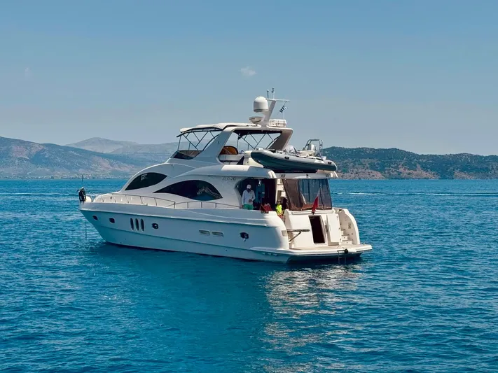  Yacht Photos Pics Majesty 66 Flybridge yacht from 2010 cruising on clear blue waters.