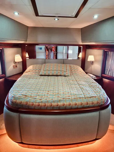  Yacht Photos Pics Luxurious bedroom interior of 2010 Majesty 66 Flybridge yacht with elegant lighting and decor.