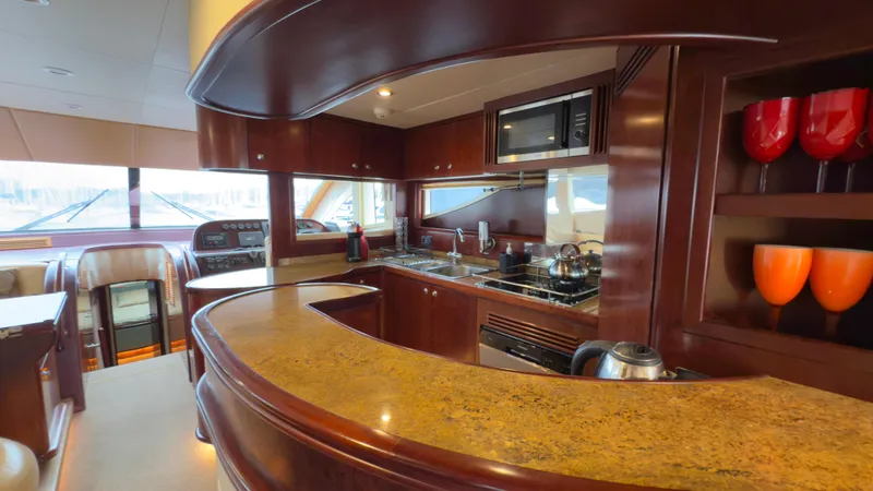  Yacht Photos Pics Luxurious kitchen interior of 2010 Majesty 66 Flybridge yacht with modern amenities.