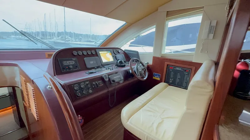  Yacht Photos Pics Luxurious 2010 Majesty 66 Flybridge yacht helm with leather seating and advanced navigation controls.