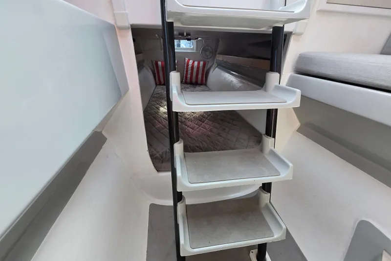 Crush Yacht Photos Pics Interior of 2022 Corsair 880 Sport boat, featuring compact cabin and ladder.
