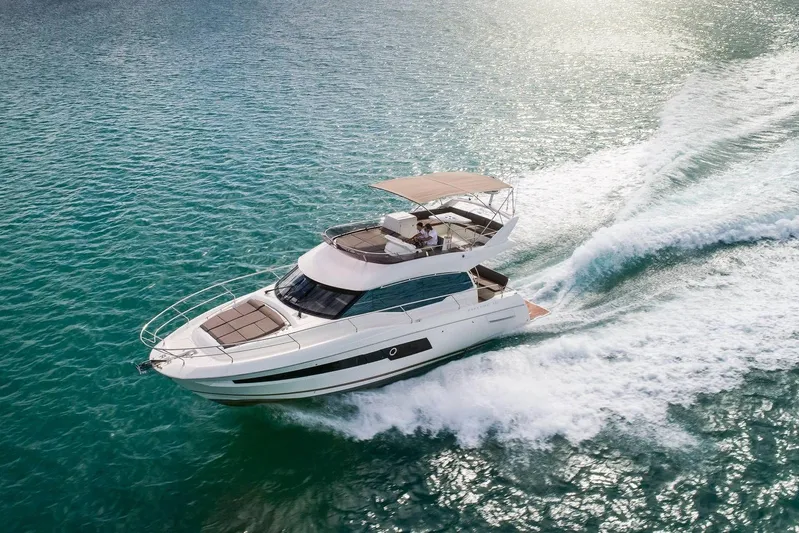  Yacht Photos Pics 2025 Prestige 460 Fly yacht cruising on clear blue water.