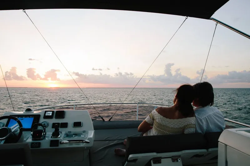  Yacht Photos Pics Couple enjoying sunset on 2025 Prestige 460 Fly yacht deck.