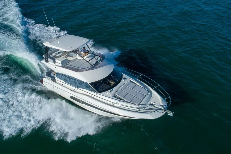  Yacht Photos Pics 2025 Prestige 460 Fly yacht cruising on open water, showcasing sleek design and luxury.