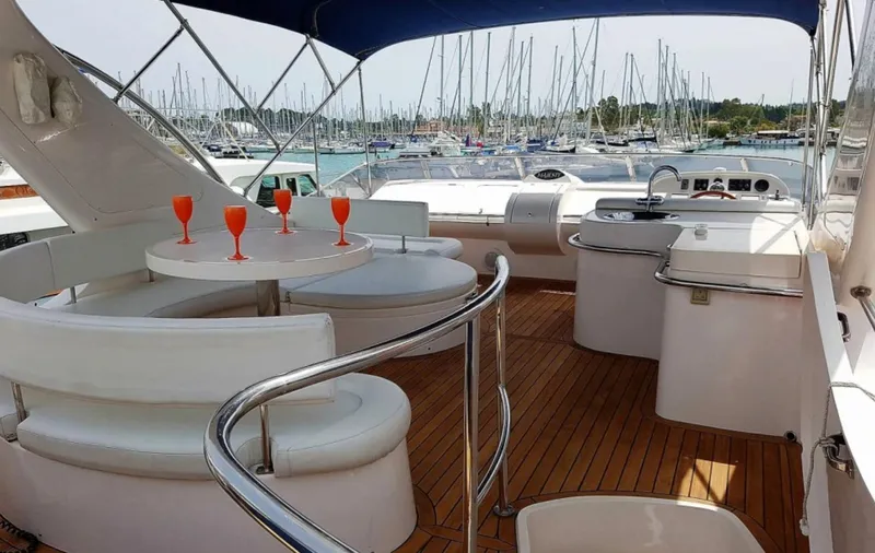  Yacht Photos Pics Majesty 66 Flybridge 2010 yacht interior with seating, table, and drinks, docked at marina.