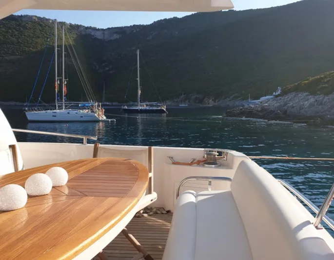  Yacht Photos Pics Majesty 66 Flybridge yacht deck with scenic coastal view, 2010 model.