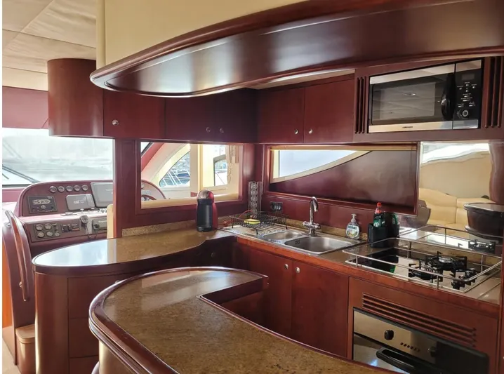  Yacht Photos Pics Luxurious kitchen interior of 2010 Majesty 66 Flybridge yacht with modern amenities.