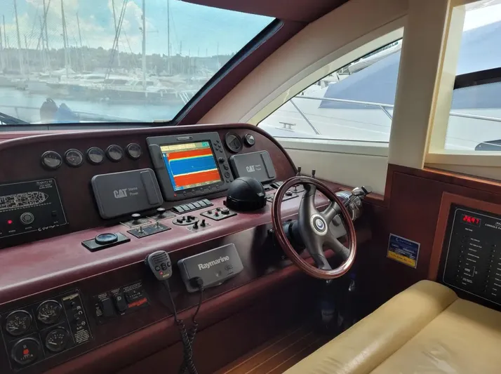  Yacht Photos Pics Majesty 66 Flybridge 2010 yacht helm with navigation controls and steering wheel.