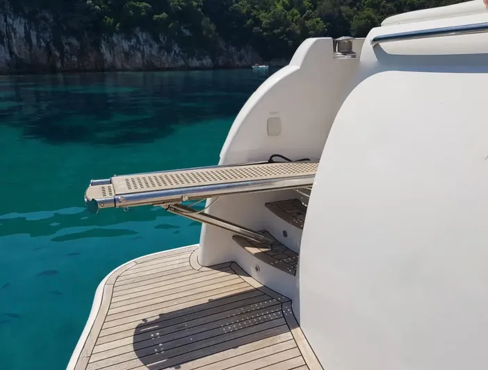  Yacht Photos Pics Majesty 66 Flybridge 2010 yacht with extended gangway over turquoise water.