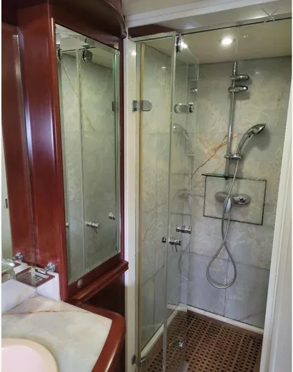  Yacht Photos Pics Luxurious bathroom shower in 2010 Majesty 66 Flybridge yacht with glass doors and modern fixtures.