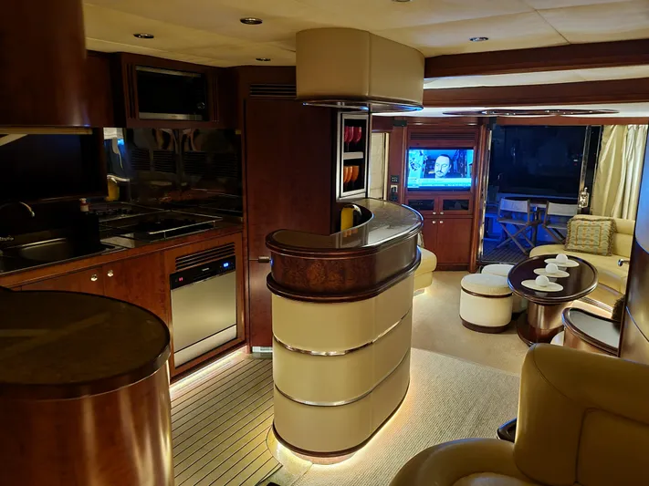  Yacht Photos Pics Luxurious interior of 2010 Majesty 66 Flybridge yacht with modern kitchen and cozy seating area.
