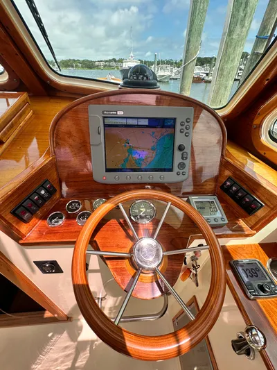  Yacht Photos Pics Helm of 2005 Hinckley 36 boat with navigation system and wooden steering wheel.