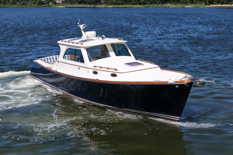  Yacht Photos Pics 2005 Hinckley 36 boat cruising on a calm lake.